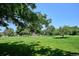 Expansive green park with mature trees, a playground, and walking paths for outdoor recreation at 12651 E Bates Cir, Aurora, CO 80014