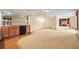 Spacious basement area with bar, wood floors, and carpet at 10011 Saddlehorn Ln, Highlands Ranch, CO 80130