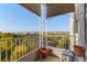 Outdoor balcony space with wrought iron details and city views with autumn foliage at 1200 N Humboldt St # 1003, Denver, CO 80218