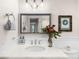 Bathroom with a marble countertop, white tiling, and a stylish mirror at 1200 N Humboldt St # 1003, Denver, CO 80218