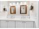 Bathroom featuring double sinks, framed mirrors, and ample counter space at 1200 N Humboldt St # 1003, Denver, CO 80218