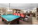 Spacious game room with a pool table, seating area, and a brick fireplace at 1200 N Humboldt St # 1003, Denver, CO 80218