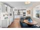 Bright kitchen features white cabinetry, stainless steel appliances, and a breakfast nook with scenic views at 1200 N Humboldt St # 1003, Denver, CO 80218