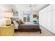 Cozy bedroom featuring a ceiling fan, balcony access, and ample closet space at 1200 N Humboldt St # 1003, Denver, CO 80218
