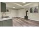 Finished basement with laminate flooring, a modern sink and countertops and a wood burning stove at 586 Alpine Way, Idaho Springs, CO 80452