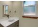 Neutral bathroom featuring a modern vessel sink, bronze fixtures, and natural light from the window at 586 Alpine Way, Idaho Springs, CO 80452
