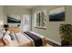 Bedroom with a light wood bed frame, door to outside, and view of forest at 586 Alpine Way, Idaho Springs, CO 80452