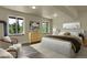 Bright bedroom featuring large windows, hardwood floors, and modern furniture and decor at 586 Alpine Way, Idaho Springs, CO 80452