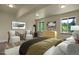 A bright bedroom with hardwood floors, two windows, and neutral decor at 586 Alpine Way, Idaho Springs, CO 80452