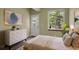 Bedroom featuring modern furniture and decor, and a door and window with forest views at 586 Alpine Way, Idaho Springs, CO 80452