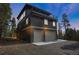 Striking modern exterior with balconies and a spacious two-car garage, set against a forested backdrop at 586 Alpine Way, Idaho Springs, CO 80452