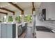 Bright kitchen features stainless steel appliances, wood beamed ceilings, and bright countertops at 586 Alpine Way, Idaho Springs, CO 80452
