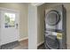 Convenient laundry room with a modern stacked washer and dryer set and exterior access at 586 Alpine Way, Idaho Springs, CO 80452
