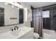 Stylist bathroom featuring black subway tile, modern vanity, and shower/tub combo at 18206 E Tanforan Pl, Aurora, CO 80015