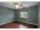Comfortable bedroom with hardwood floors, ceiling fan, and a window at 18206 E Tanforan Pl, Aurora, CO 80015