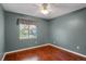 Cozy bedroom with hardwood floors, ceiling fan, and window with natural light at 18206 E Tanforan Pl, Aurora, CO 80015