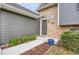 Close-up of the front entrance with a brick facade and manicured landscaping at 18206 E Tanforan Pl, Aurora, CO 80015