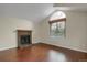 Cozy living room featuring a brick fireplace and hardwood floors at 18206 E Tanforan Pl, Aurora, CO 80015