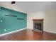Hardwood floored living room featuring a fireplace and shelving at 18206 E Tanforan Pl, Aurora, CO 80015