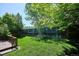 Spacious backyard with a wooden deck, a lush lawn, and privacy fence perfect for outdoor living at 5651 S Himalaya Way, Centennial, CO 80015