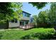 Green home exterior with a wooden deck overlooking the lush, green backyard at 5651 S Himalaya Way, Centennial, CO 80015