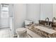 Bathroom with a toilet, vanity with granite countertop, and a laundry room at 5651 S Himalaya Way, Centennial, CO 80015