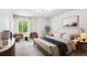 Bright bedroom featuring large windows, neutral tones, and stylish furnishings, enhancing comfort and relaxation at 5651 S Himalaya Way, Centennial, CO 80015