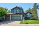 Charming two-story home with a three-car garage and mature landscaping at 5651 S Himalaya Way, Centennial, CO 80015