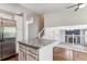 Kitchen island with granite countertop open to the living room with hardwood floors and a staircase at 5651 S Himalaya Way, Centennial, CO 80015