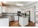 Bright kitchen featuring white cabinets, stainless steel appliances, granite countertops, and hardwood flooring at 5651 S Himalaya Way, Centennial, CO 80015