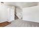 Bright living room with carpet, a staircase, and a large window at 5651 S Himalaya Way, Centennial, CO 80015