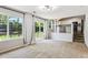 Living room with large windows and a sliding door to the backyard deck open to the kitchen at 5651 S Himalaya Way, Centennial, CO 80015
