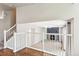 View from the top of the staircase into the living room with a fireplace at 5651 S Himalaya Way, Centennial, CO 80015