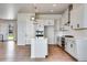 Modern kitchen with white cabinets, island, and stainless steel appliances at 14408 Hop Clover Trl, Parker, CO 80134