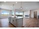 Modern kitchen with island, stainless steel appliances, and stunning views at 14408 Hop Clover Trl, Parker, CO 80134