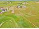 Aerial view of the home surrounded by green pastures, a charming tree, and serene landscape at 14825 Almstead St, Hudson, CO 80642
