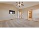 Spacious carpeted bedroom with neutral walls, ceiling fan, and multiple doorways providing comfort and accessibility at 14825 Almstead St, Hudson, CO 80642