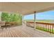 A spacious wood deck showcases views of the surrounding green meadows and blue skies at 14825 Almstead St, Hudson, CO 80642