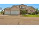 Inviting two-story home featuring a three-car garage and mature landscaping at 14825 Almstead St, Hudson, CO 80642