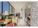 Bright enclosed balcony featuring ample seating and a view to the outdoors at 7020 E Girard Ave # 209, Denver, CO 80224