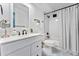 Beautifully designed bathroom with tiled floor, white vanity, and shower with black hardware at 7020 E Girard Ave # 209, Denver, CO 80224