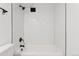 Updated bathtub and shower with white subway tile, black showerhead and trim at 7020 E Girard Ave # 209, Denver, CO 80224