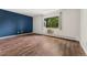 This empty bedroom features hardwood floors and a treelined view at 7020 E Girard Ave # 209, Denver, CO 80224