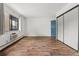 Bright bedroom featuring hardwood floors, a large window, and closet at 7020 E Girard Ave # 209, Denver, CO 80224