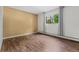Bright bedroom features wood floors and a large window with neutral-toned curtains at 7020 E Girard Ave # 209, Denver, CO 80224
