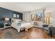 Comfortable bedroom with ample natural light, modern decor, and hardwood flooring at 7020 E Girard Ave # 209, Denver, CO 80224