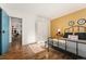 Cozy bedroom showcasing wood floors, black metal bed frame, and blue painted door at 7020 E Girard Ave # 209, Denver, CO 80224