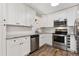 Updated kitchen with white cabinets, granite countertops, and stainless steel appliances at 7020 E Girard Ave # 209, Denver, CO 80224