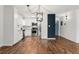 Open kitchen with modern light fixture and stainless appliances with white cabinets at 7020 E Girard Ave # 209, Denver, CO 80224