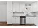 This kitchen features white cabinets, stainless steel appliances, granite countertops, and a subway tile backsplash at 7020 E Girard Ave # 209, Denver, CO 80224